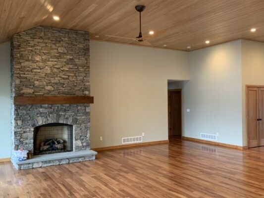 Beautiful living room with custom rock chimney